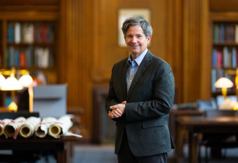 Doug Boyd standing in a wood-paneled room