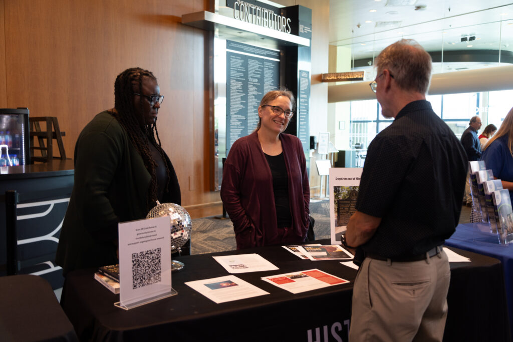 Attendees visiting the University of Louisville partner booth at at KET's Louisville event.